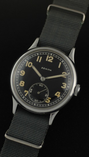 1940s Zenith stainless steel WW2 German military watch with original glossy black dial, aged Arabic numerals, hands, and manual movement.