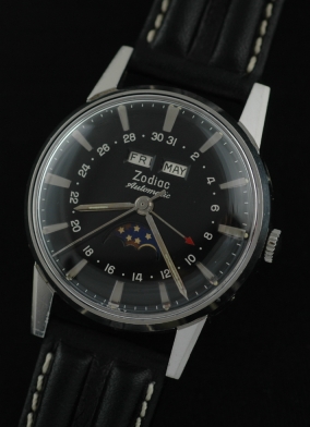 1950s Zodiac Automatic stainless steel moonphase watch with original restored black dial, hands, date pointer, and Swiss-made movement.