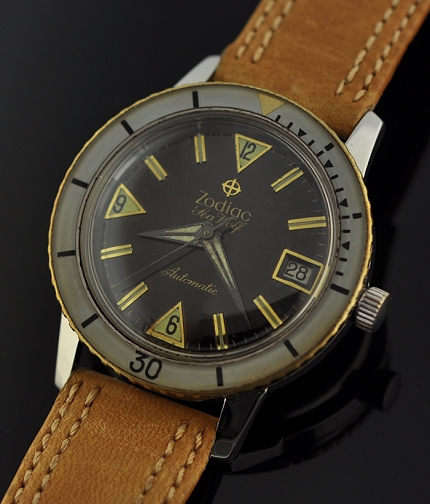 1960s Zodiac Sea Wolf stainless steel watch with original black dial, triangular/baton markers, case, and automatic rotor winding movement.