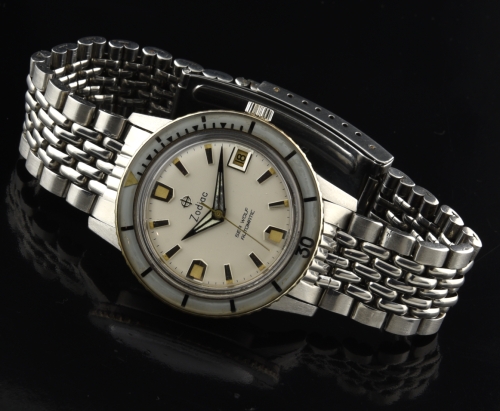 1960s Zodiac Sea Wolf stainless steel watch with original dial, sword hands, beads-of-rice bracelet, bezel, and automatic Zenith movement.