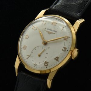 1955 Longines 18k solid-gold watch with original small size, dog-leg angled lugs, case, dial, and cleaned, accurate caliber 23Z movement.