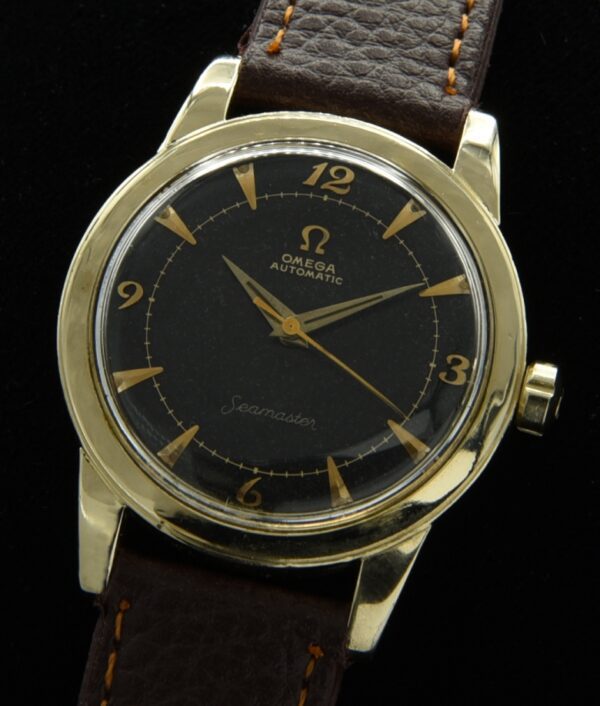1955 Omega Seamaster 14k gold-filled watch with original notched winding crown, black dial, Breguet numerals, and caliber 500 movement.