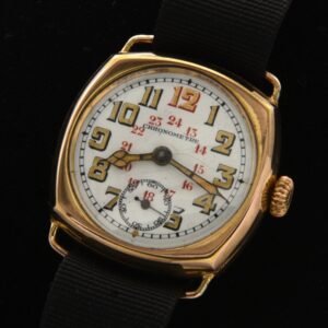 This circa 1915 military WW1-era trench has a very attractive original porcelain dial accented with red 24 hr. military scale, large radium numeral and cathedral hands.
