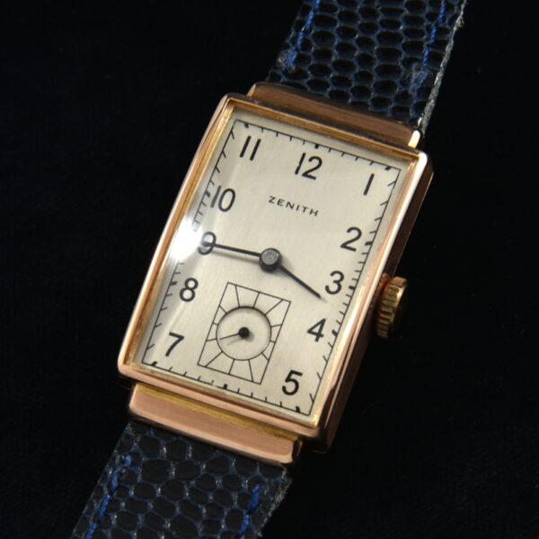 This is an 18k solid rose gold vintage 1940s rectangular Zenith manual winding watch. The 18k rose gold case measures an elongated 21x36.5mm.