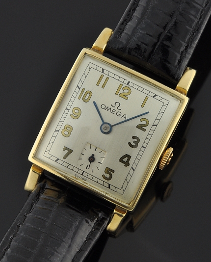 1944 Omega 14k yellow-gold watch with original winding crown, curved case, hands, Arabic numerals, and cleaned manual winding movement.