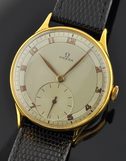 1944 Omega gold-plated oversized watch with original restored dial, reflective rose-toned Arabic numerals, and caliber 30T2 fine movement.