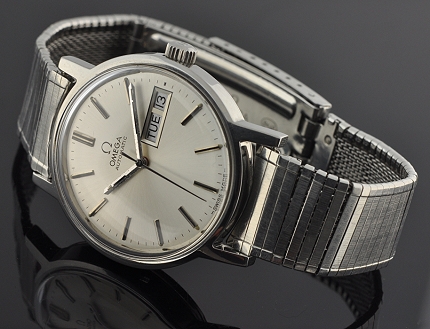 1974 Omega stainless steel watch with original case, winding crown, crystal, silver dial, baton hands, and clean automatic winding movement.