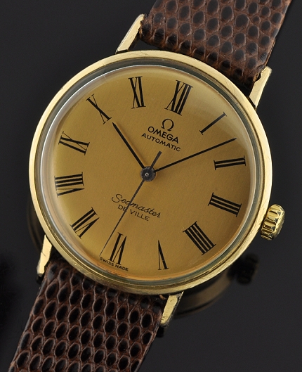 1960s Omega Seamaster De Ville gold-filled watch with original sea-monster case, winding crown, Roman-numeral dial, and automatic movement.