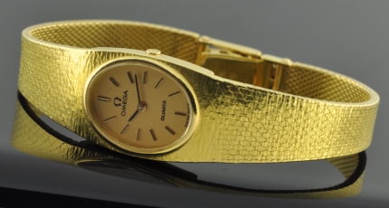 1980s Omega Quartz 18k solid-gold watch with original 7" bracelet, substantial amount of gold, and battery operated movement.