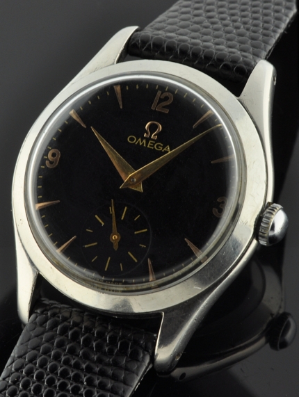 1950 Omega stainless steel watch with original refinished black dial, gold-toned Arabic numerals, arrow markers, Dauphine hands, and bezel.