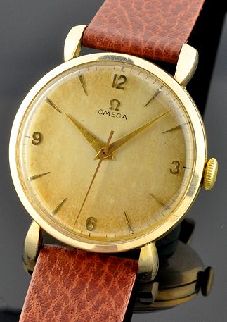 1956 Omega gold-plated watch with original oversized case, restored dial, downturned lugs, and cleaned caliber 283 manual winding movement.