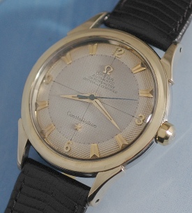 1951 Omega Constellation gold and steel watch with original curved lugs, bezel, quadrant dial, and caliber 354 bumper automatic movement.