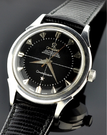 1956 Omega Constellation stainless steel watch with original black pie-pan dial, Dauphine hands, winding crown, and caliber 505 movement.