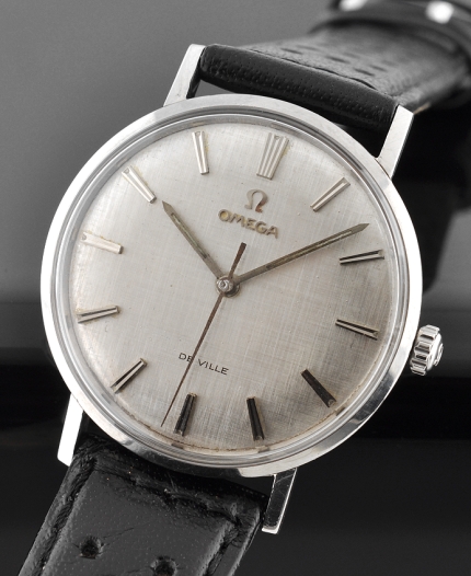 Omega De Ville stainless steel watch with original subtle size, crosshatched dial, case, winding crown, and reliable automatic movement.