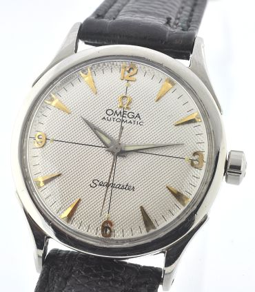 1947 Omega Seamaster stainless steel watch with original restored engine-turned dial, gold-toned markers, Dauphine hands, and winding crown.
