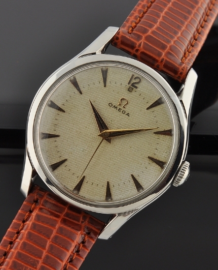 1951 Omega stainless steel oversized watch with original narrow bezel, linen dial, gold-toned markers, and caliber 283 manual movement.