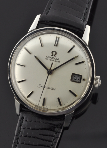 1967 Omega Seamaster stainless steel watch with original case, winding crown, sword hands, silver dial, and caliber 565 automatic movement.