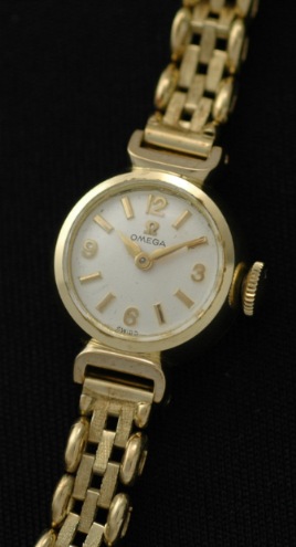 1960 Omega 14k yellow-gold-filled ladies cocktail watch with original silver dial, serpentine bracelet, Dauphine hands, and clean movement.
