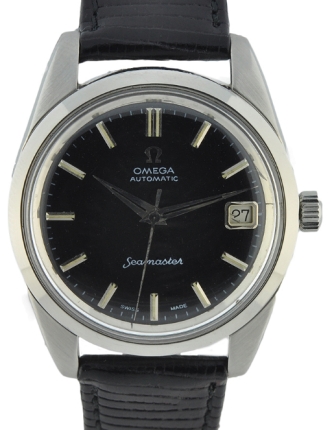 Omega Seamaster stainless steel watch with original date aperture, screw-back case, raised relief logo, and caliber 562 automatic movement.