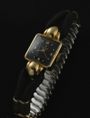 1945 Rolex 18k yellow-gold ladies cocktail watch with original case, bulbous lugs, stretch bracelet, dial, and manual winding movement.