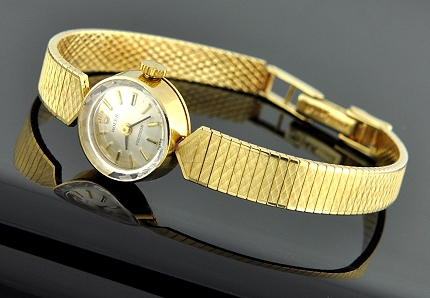 1964 Rolex Precision 14k solid-gold watch with original dial, raised markers, faceted glass crystal, and cleaned manual winding movement.