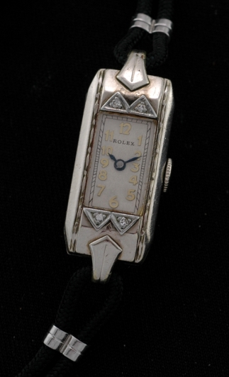 1930s Rolex white-gold-filled cocktail watch with original hand-carved sides, diamond bezel, restored dial, and signed manual movement.