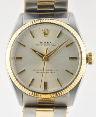 1965 Rolex Oyster Perpetual gold and steel watch with original two-tone bracelet, bezel, markers, Dauphine hands, and automatic movement.
