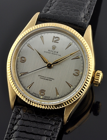 1947 Rolex Oyster Perpetual 18k solid-gold watch with original crystal, crown, restored silver dial, and cleaned automatic winding movement.