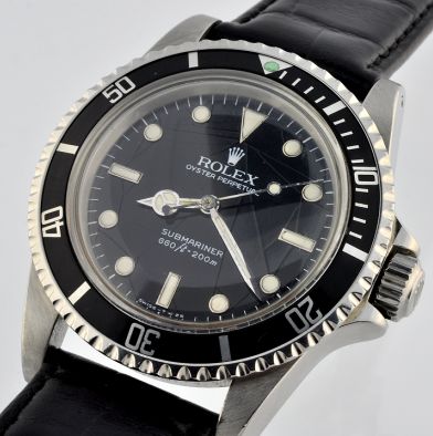 1984 Rolex Oyster Perpetual Submariner stainless steel watch with original spider-web dial, white-gold markers, and caliber 1520 movement.