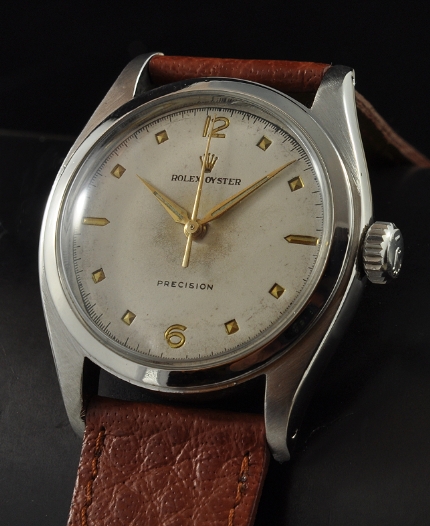 1953 Rolex Oyster Precision stainless steel watch with original restored dial, Dauphine hands, gold-toned markers, and caliber 710 movement.