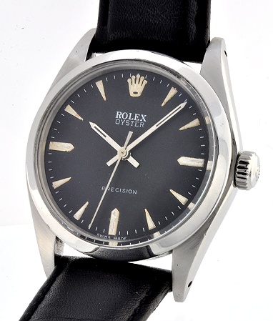 1973 Rolex Oyster Precision stainless steel watch with original restored black dial, baton hands, markers, and manual winding movement.