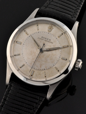 1954 Rolex Oyster-Perpetual stainless steel watch with original flat-sided case, bullseye dial, Dauphine hands, and caliber 1030 movement.