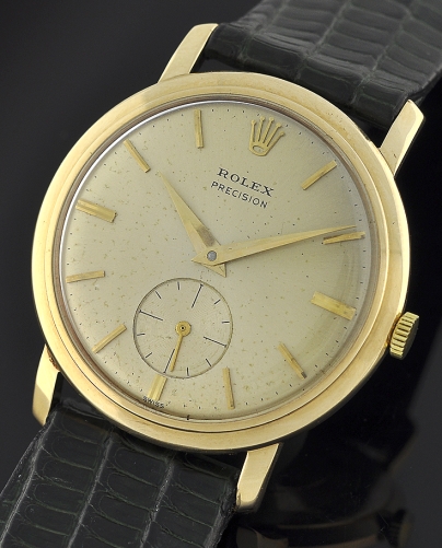 1962 Rolex Precision 9k gold dress watch with original Dennison case, stepped bezel, dial, Dauphine hands, and manual winding movement.