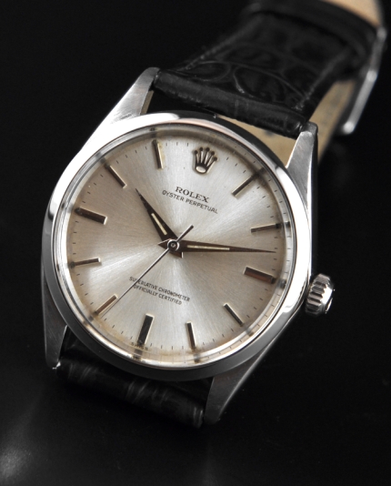 1960 Rolex Oyster Perpetual stainless steel watch with original case, silver dial, Dauphine hands, markers, and clean automatic movement.