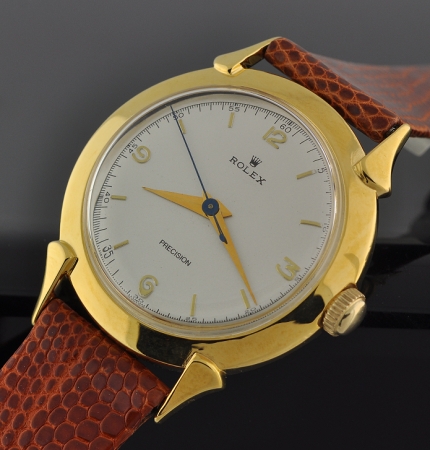 1950s Rolex Precision Dustproof gold-plated watch with original signed case, winding crown, restored dial, and manual winding movement.