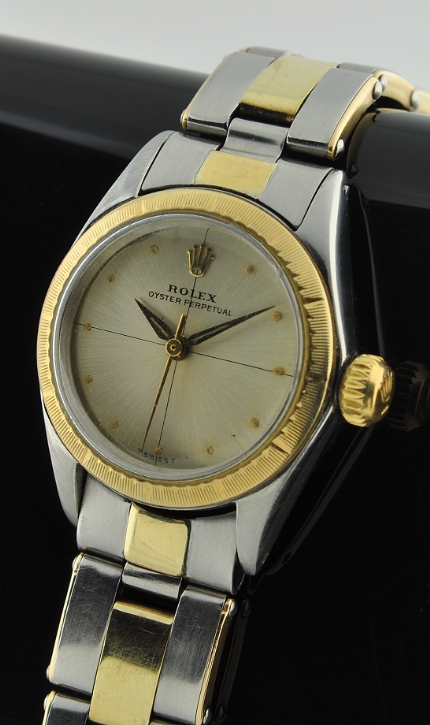 1967 Rolex Oyster Perpetual gold and steel watch with original two-tone bracelet, 25mm case, engine-turned bezel, and automatic movement.