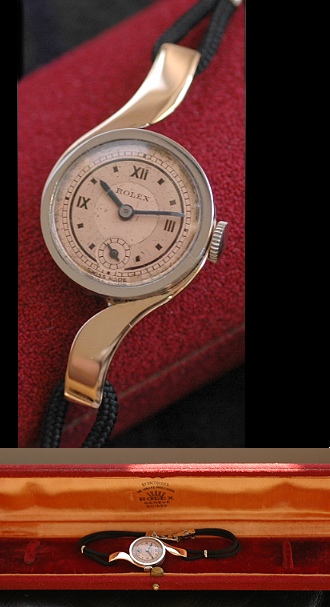 1927 Rolex 18k pink-gold cocktail watch with original spiraling lugs, bezel, lugs, two-tone dial, Roman numerals, and clean manual movement.