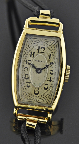 1938 Rolex gold-filled cocktail watch with original barrel-shaped case, art-deco dial, cathedral hands, and six-position Prima movement.