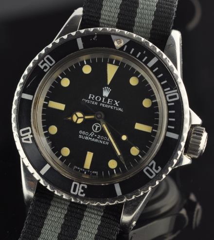 1973 Rolex Oyster Perpetual Submariner Milsub stainless steel watch with original case, T dial, markings, hands, NATO strap, and fixed lugs.