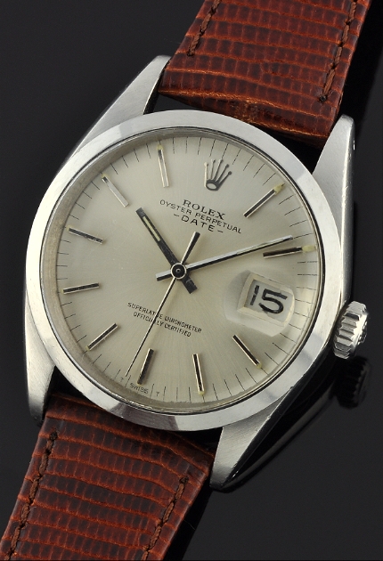 1967 Rolex Oyster Perpetual Date stainless steel watch with original case, dial, elongated baton markers, hands, and automatic movement.