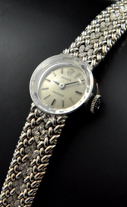 1960s Rolex Precision 14k yellow-gold ladies cocktail watch with original dial, faceted crystal, integrated bracelet, and manual movement.