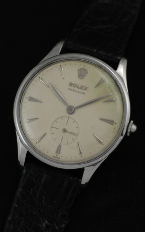 1946 Rolex Precision stainless steel watch with original eggshell dial, arrow markers, Arabic numerals, and cleaned manual winding movement.