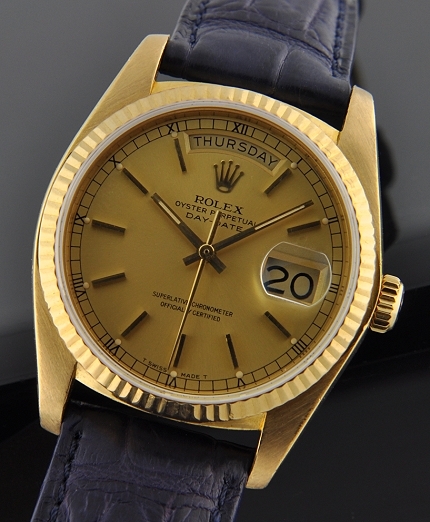 1989 Rolex Oyster Perpetual Day-Date 18k gold watch with original scratchless case, sapphire crystal, Roman dial, and serviced movement.