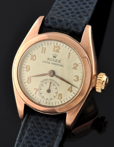 1938 Rolex Oyster Perpetual Super Precision 9k rose-gold watch with original bubbleback case, dial, and cleaned automatic winding movement.