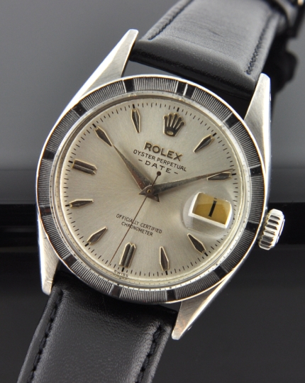 1958 Rolex Oyster Perpetual Date stainless steel watch with original engine-turned bezel, Dauphine hands, silver dial, and clean movement.