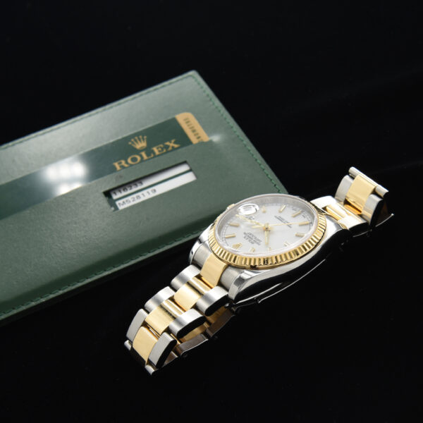 This is a 36mm ref. 116233 Two-Tone Rolex Datejust in 18k-gold and steel with the desirable Rolex Oyster flip-lock bracelet dating to 2008.