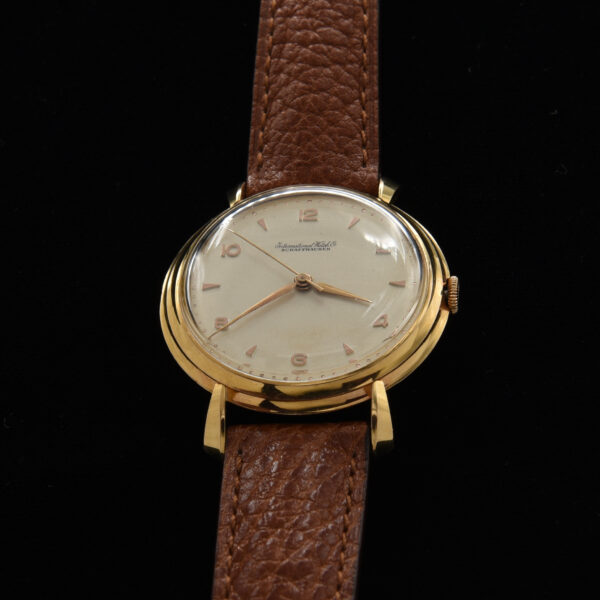 This is a prime example of an original vintage IWC in solid 18k gold measuring a large 37mm. The original dial is highlighted with rose toned Arabic and arrow markers and Lance style hands.