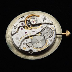 This is a manual winding Gerald Genta 18 jewel manual winding vintage movement which is adjusted to six positions. The cabochon crown and marble dial is still attached.