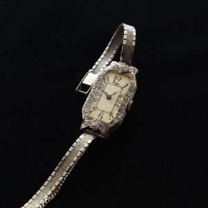 This is a beautiful vintage 1930s platinum and diamond watch measuring 16.5x32.5mm, which is actually considered large from this era.