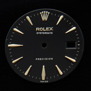 This is a 27.6mm Rolex Oysterdate black restored amazing-looking dial with extended original gold-toned applied markers.